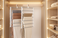 SpaceSaver Multi-Layer Pants Organizer in a clean organized wardrobe